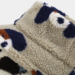 Close-up of thick sherpa fleece fabric showing the blue and brown jacquard pattern texture