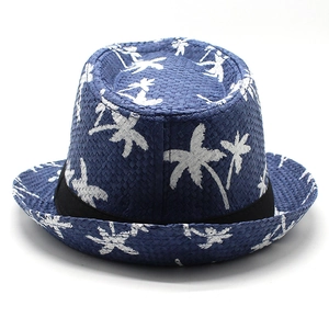Close-up of blue straw Panama hat featuring white coconut palm tree prints and black band