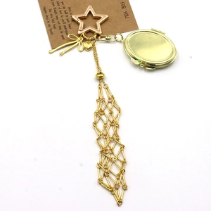 Golden metal mesh keychain with star, heart, and photo locket on a For You gift card