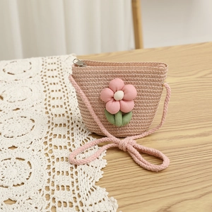 Detail of child straw crossbody bag with large pink fabric flower and zip closure