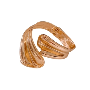 Minimalist twisted wave open cuff bracelet in rose gold finish with textured design