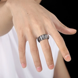 Detailed close-up of retro silver snake scale texture on stainless steel ring for men