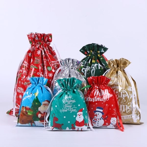 Christmas drawstring gift bags in assorted festive colors and holiday patterns