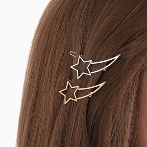 Elegant gold and silver star and moon hollow hair clips on a female model's hair