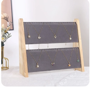 Detail of two-tier necklace display stand with grey velvet and wooden frame for jewelry organizer