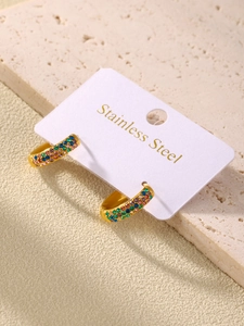 Detail of gold-plated stainless steel hoop earrings with colorful inlaid zircon stones
