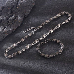 Macro detail of industrial style hexagonal nut chain necklace and bracelet set in gunmetal