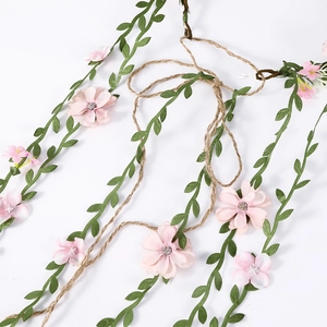 Bohemian floral rattan headband with pink flowers and green leaves on brown twine