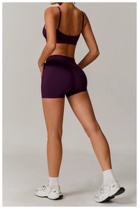 Detail view of the back of a deep purple yoga set with high-waist shorts and a sports bra