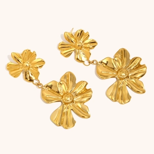 Detailed view of layered double flower drop earrings in 18K gold plated stainless steel