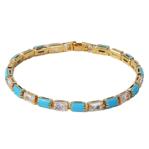 Elegant gold plated tennis bracelet featuring turquoise stones and cubic zirconia on white background
