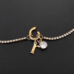 Exquisite gold-tone titanium steel tennis necklace with letter r and sparkling CZ pendant.