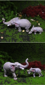 Detailed close-up showing realistic skin texture and painted details of mother and baby elephant