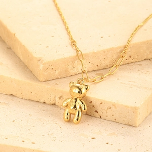 Detailed view of golden 3D teddy bear pendant with heart and LOVE engravings on necklace