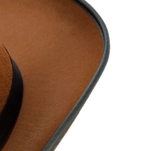 Close-up of brown western cowboy hat showing premium wool texture and leather edge trim