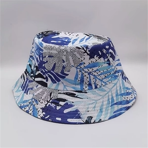 Detail of blue and white tropical leaf pattern on reversible cotton bucket hat