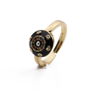 Close-up of gold plated ring with black enamel evil eye and colorful zircon stones