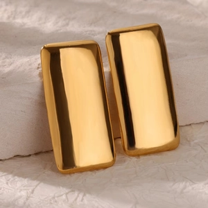 Polished 18K gold rectangular hoop earrings on stone background for women