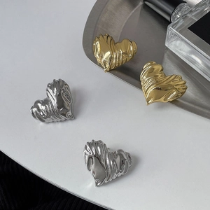 Minimalist heart-shaped earrings with pleated metallic texture in gold and silver finish