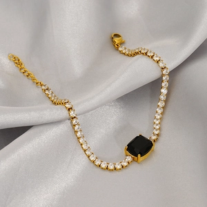 Elegant gold tennis bracelet with circular zircons and a black rectangular gemstone