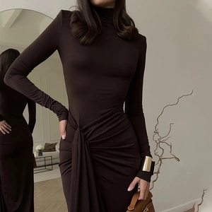 Detail of high neck dark brown long sleeve dress with waist twist and ruching effects
