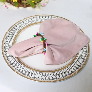 Easter napkin ring with colorful berries on pink velvet napkin and white plate