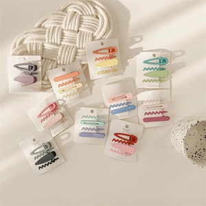 Detailed view of various colorful metal hair clip sets in multiple shapes and pastel tones