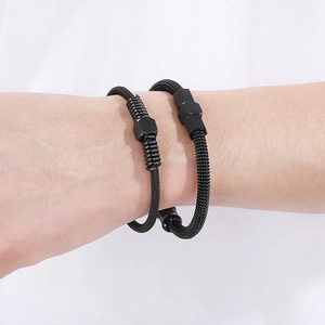 Macro shot of twisted cable bracelets with hexagonal beads on a white background