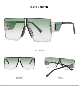 Detail view of square rimless sunglasses with green gradient lenses and silver temples