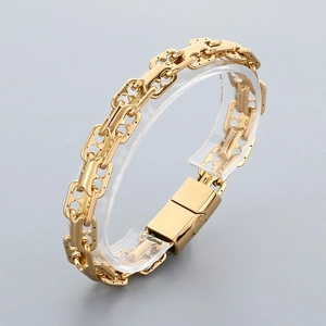 Detailed view of golden double-row link chain bracelet with polished metallic finish
