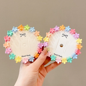 Colorful mini flower hair claws for kids in pastel macarons colors set on white cards