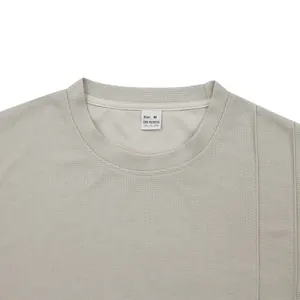 Detail of grey crewneck t-shirt neckline showing 100% polyester breathable honeycomb texture