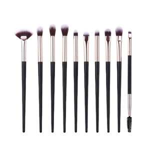 Set of 10 professional makeup brushes with rose gold ferrules on white background