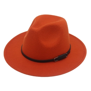 Detailed close-up of an orange wide-brim felt fedora with a black leather band and buckle