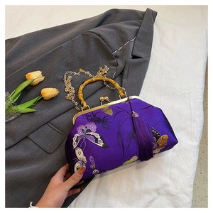 Detail of purple embroidery bag with bamboo handle, butterfly patterns and silk tassel