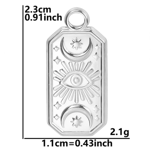 Macro view of silver evil eye pendant with sun and moon relief, measuring 2.3cm by 1.1cm