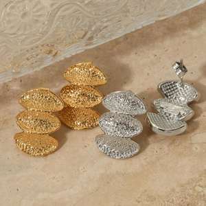 Textured 3-tier stacked fan earrings in gold and silver finish on marble surface