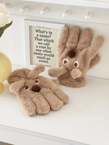 Close-up of brown plush cartoon gloves with soft faux fur texture and embroidered dog face