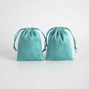 Mint green flannel drawstring jewelry pouch with soft suede texture for gift packaging