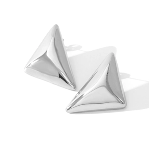 Macro detail of high-polish 3D triangle stud earrings in minimalist stainless steel