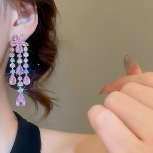 Detail of pink crystal flower earrings with long tassels and teardrop pendants