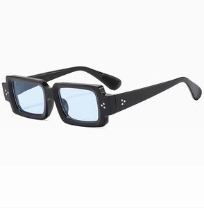 Detail view of square black sunglasses with light blue lenses and silver rivets