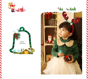 Close-up of kids Christmas headband with red sequin reindeer antlers and white pom-poms