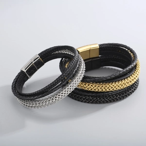 Macro detail of braided leather bracelets with steel wheat chains and magnetic clasps