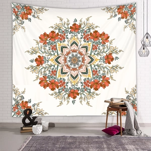 Bohemian mandala wall tapestry with orange floral design in a cozy room setting