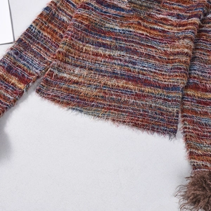 Detail of colorful striped knit fabric with plush fringed texture and raw edge finish