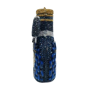 Macro detail of cylindrical crystal clutch bag with blue and silver rhinestones