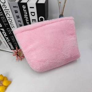 Close-up of pink plush makeup bag texture with soft faux fur and minimalist design