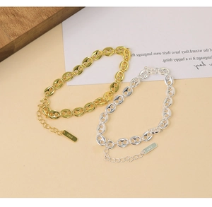 Close-up of gold and silver S925 sterling silver pig nose chain bracelets with tag