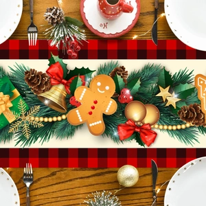 Detail of Christmas table runner with gingerbread man, pine branches and red plaid border